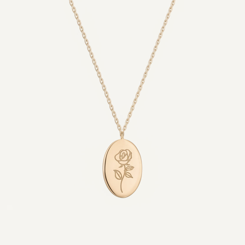 Gold necklace with a rose pendant on a white background