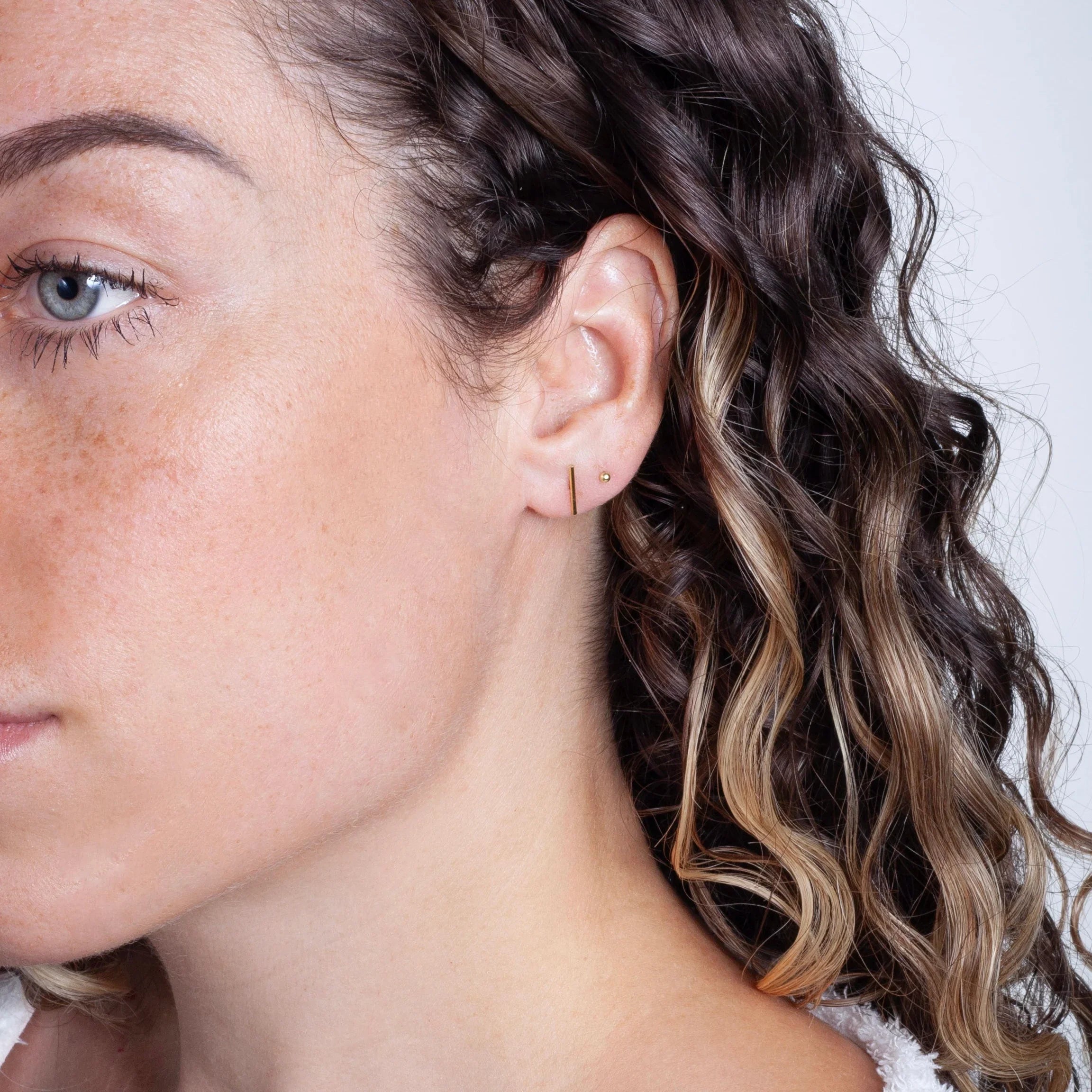 Gold filled bar stud earrings – on ear