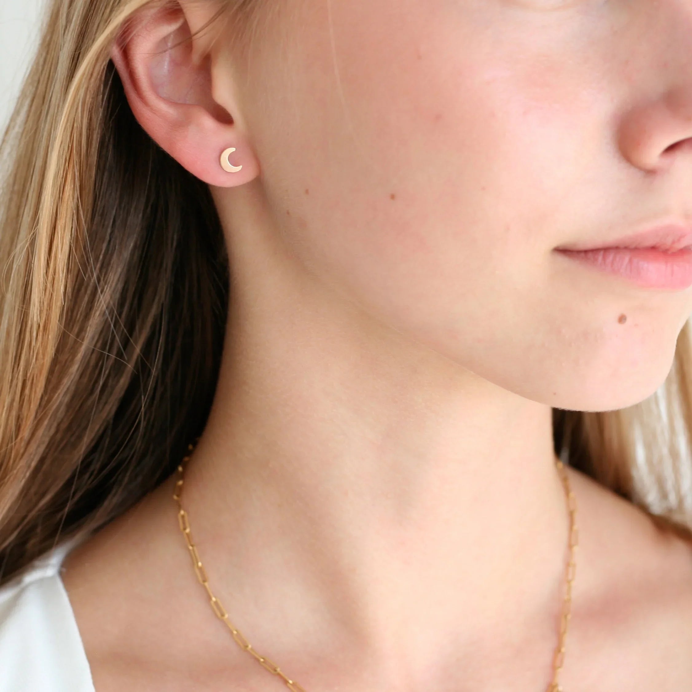 Gold filled crescent moon stud earrings – on ear