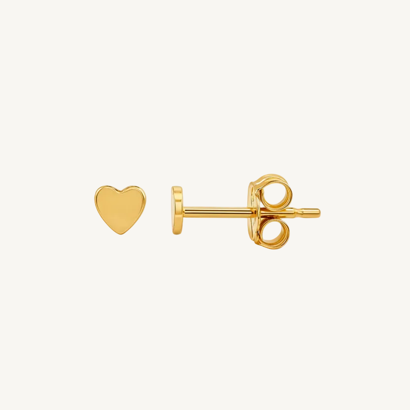 Gold heart-shaped earring on a white background