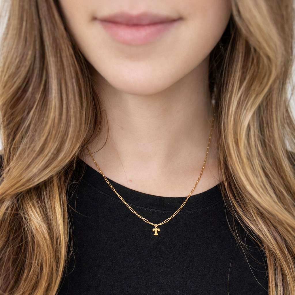 gold initial necklace on model