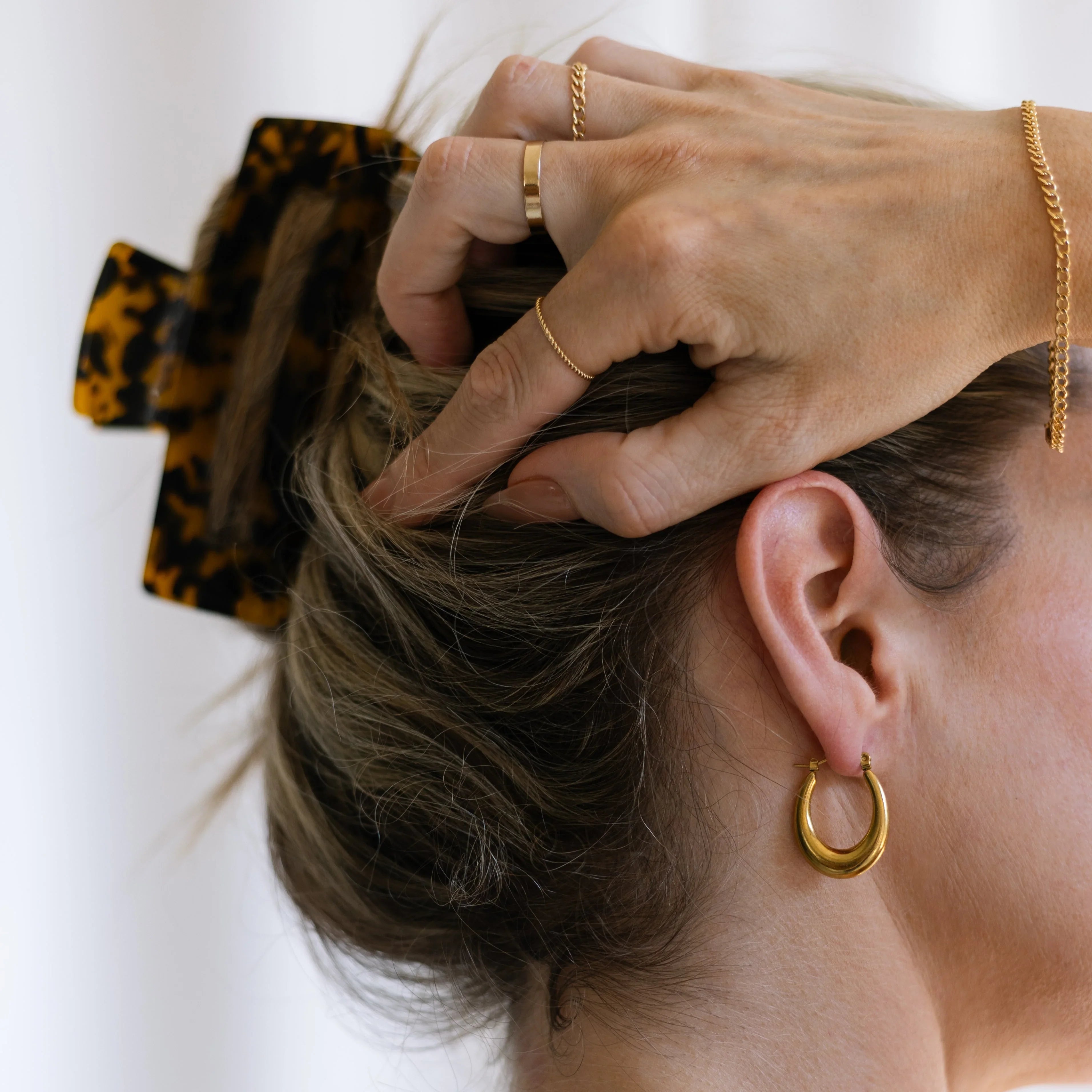 gold plated tapered hoops on ear