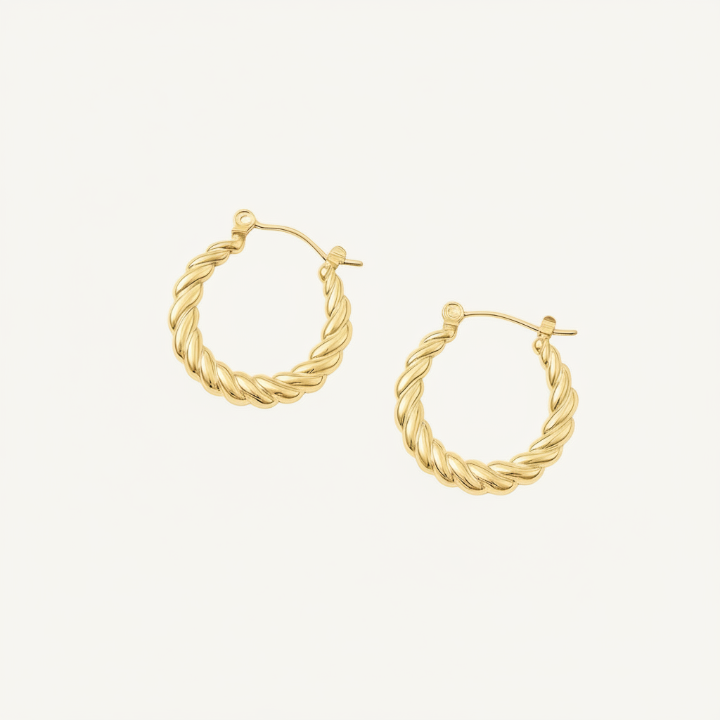 Pair of gold twist hoop earrings on a white background