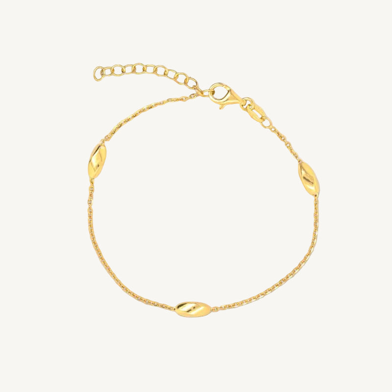 Gold marquise station bracelet on a white background