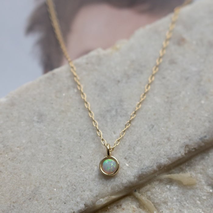 Delicate opal pendant necklace with iridescent stone