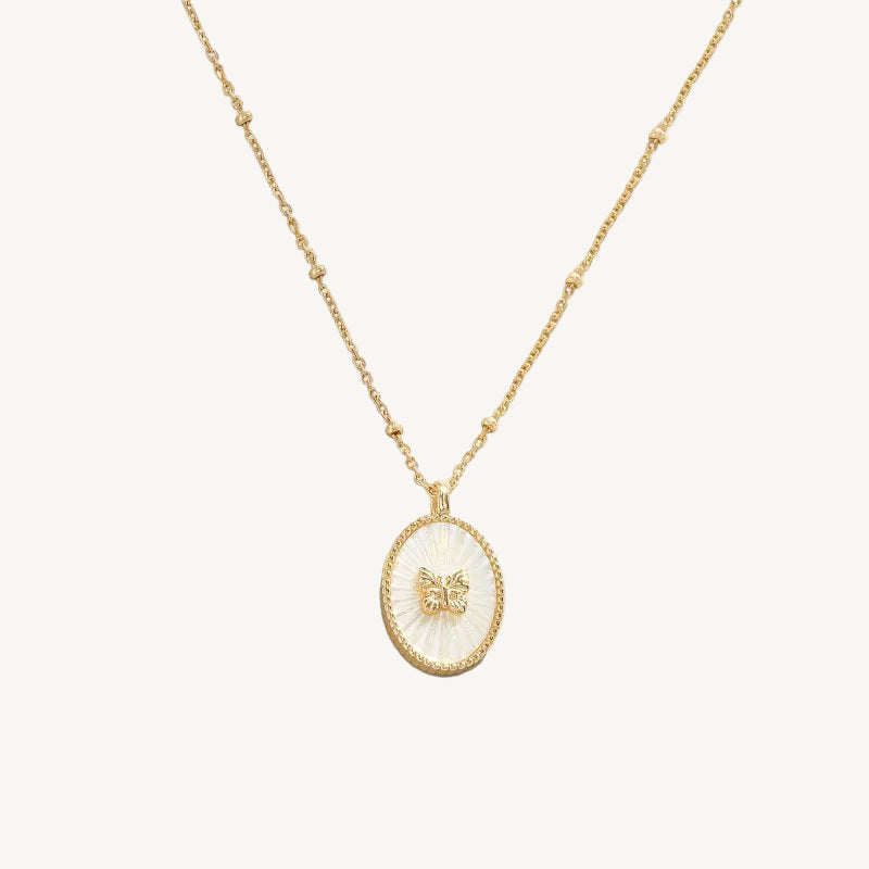 Gold necklace with a butterfly pendant on a white background