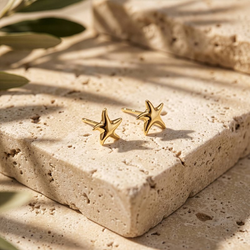 gold starfish studs on tile