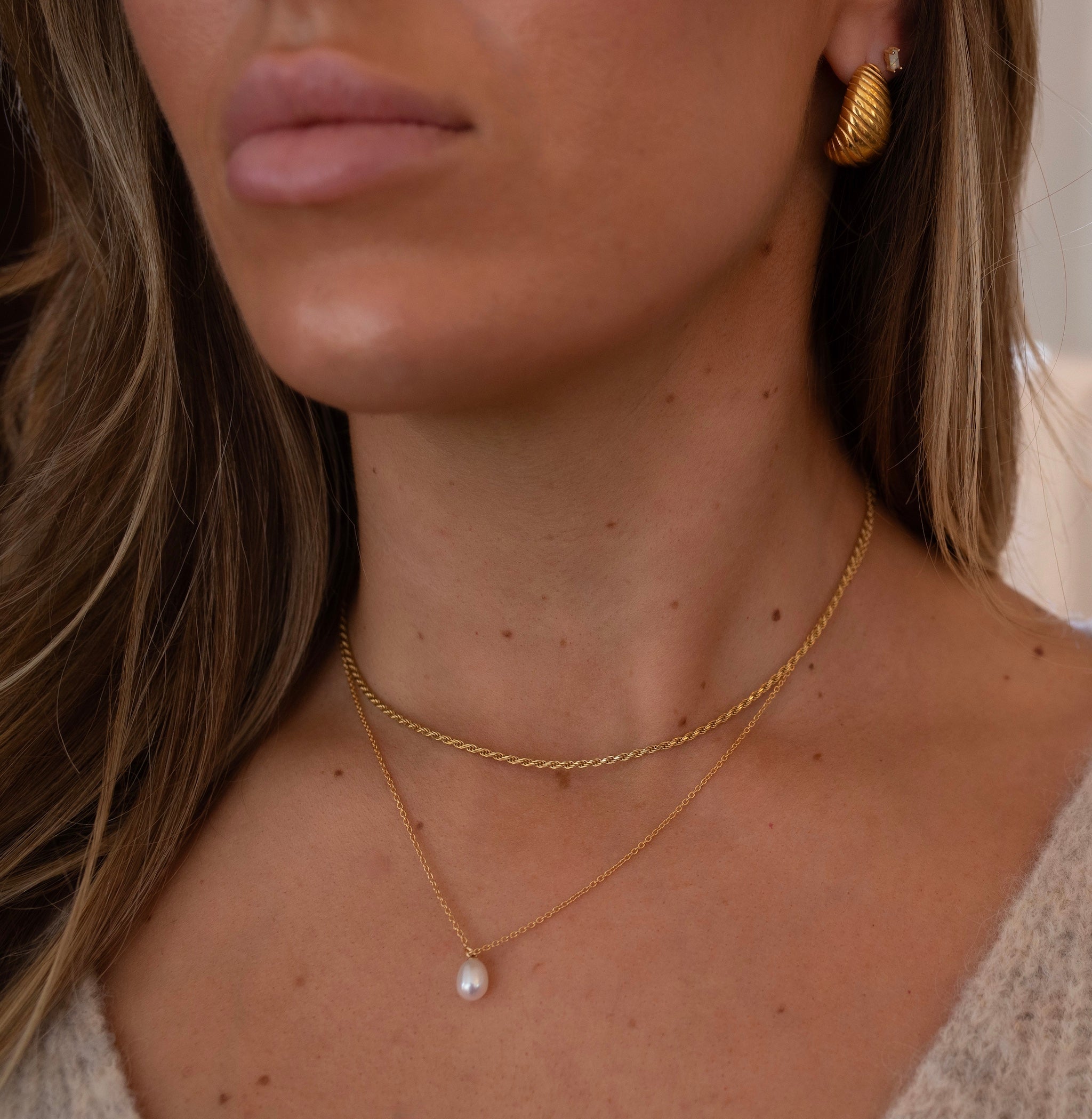 model wearing dainty pearl pendant necklace on a gold filled chain