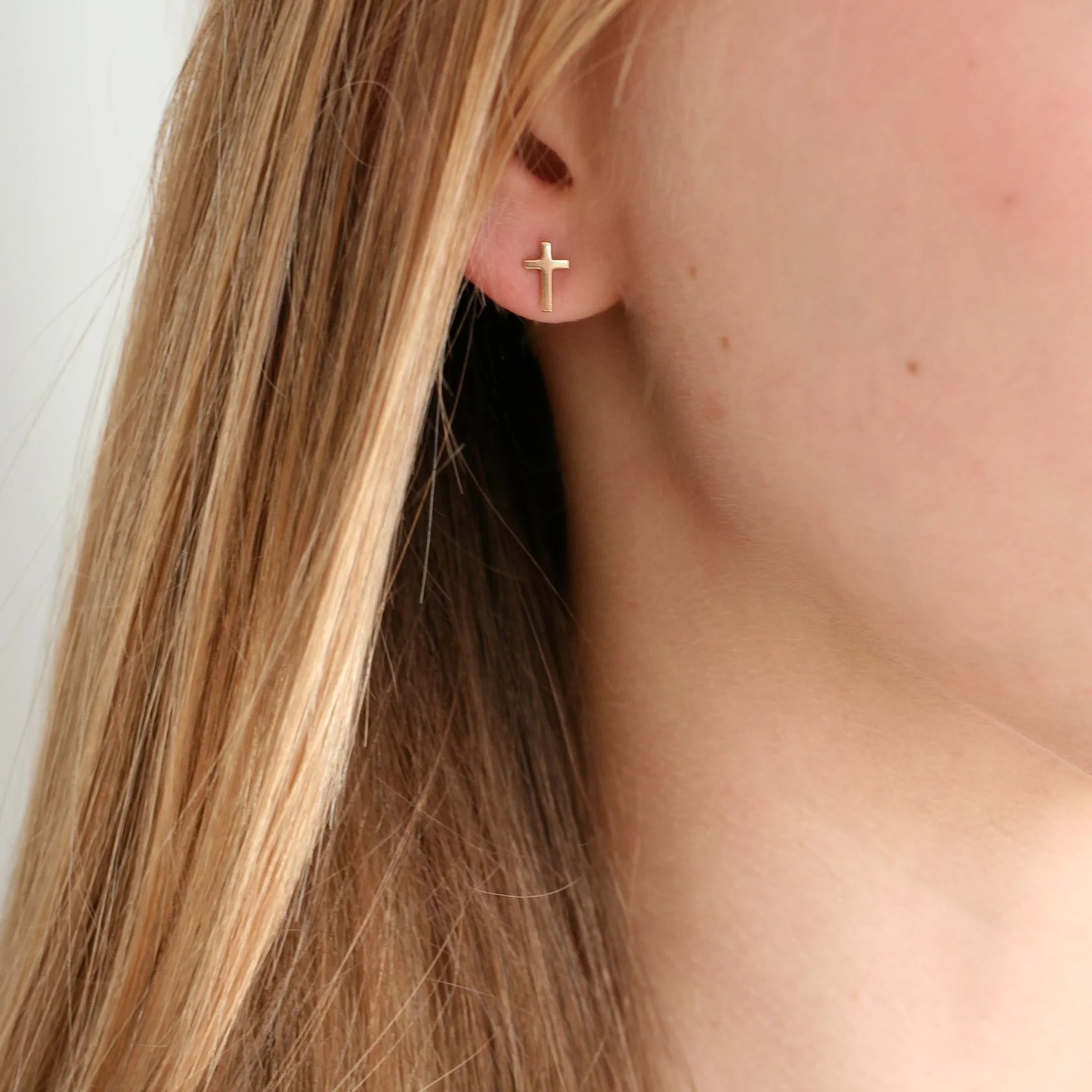 10k Gold Cross Studs on model