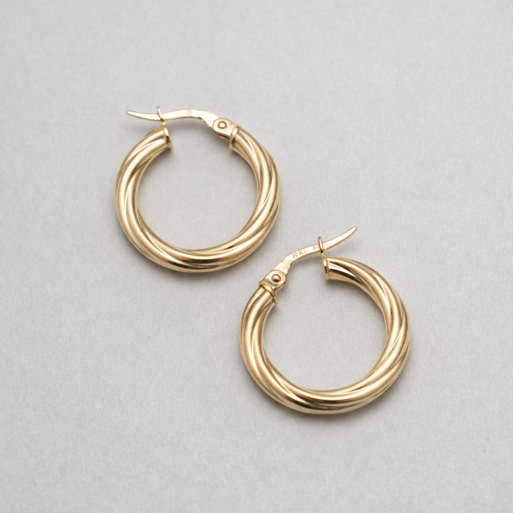 Gold hoop earrings on a light gray background
