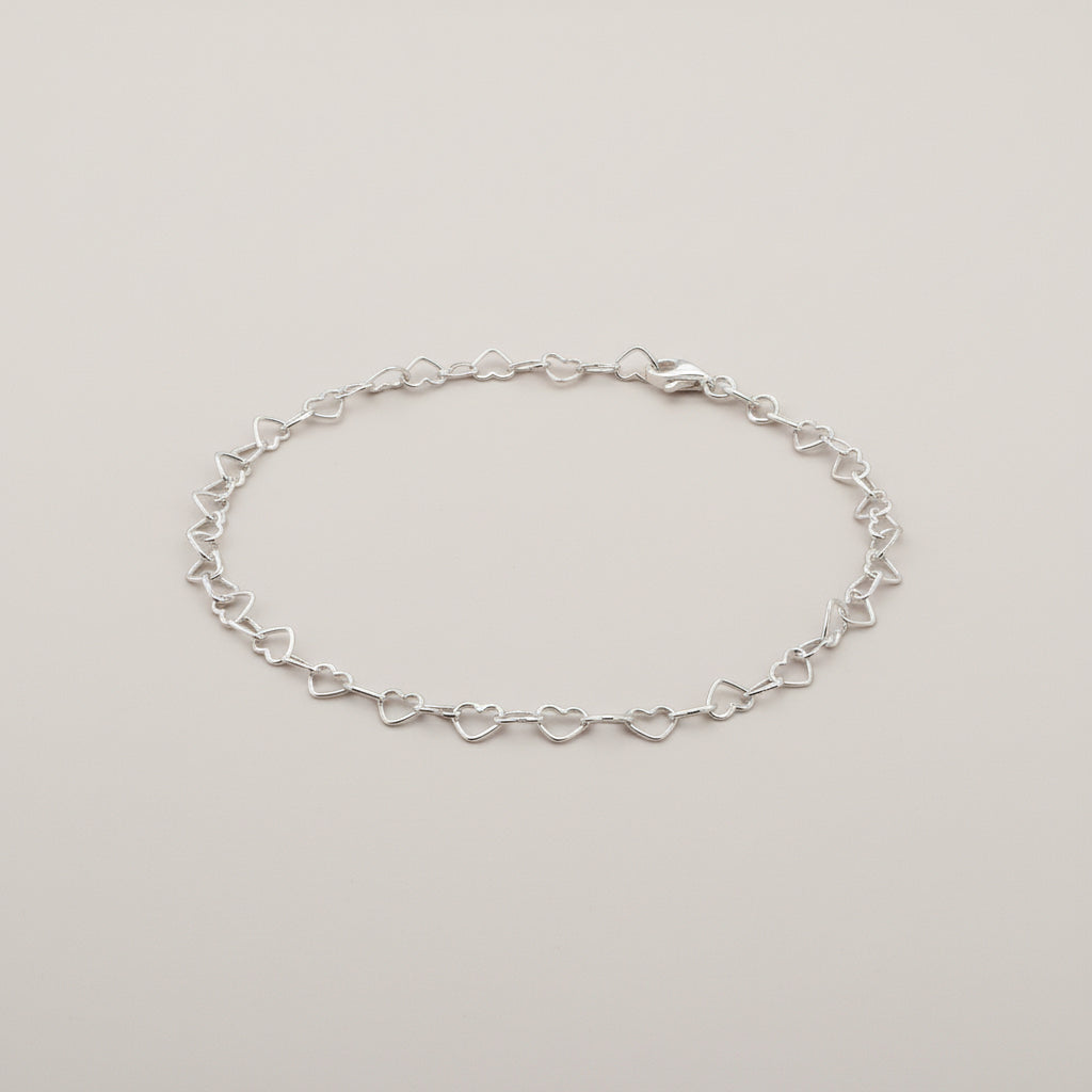 Minimal sterling silver anklet featuring heart-shaped chain links