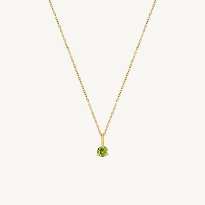 Gold necklace with a peridot  gemstone pendant on a white background