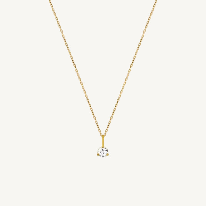 Gold necklace with a small diamond pendant on a white background