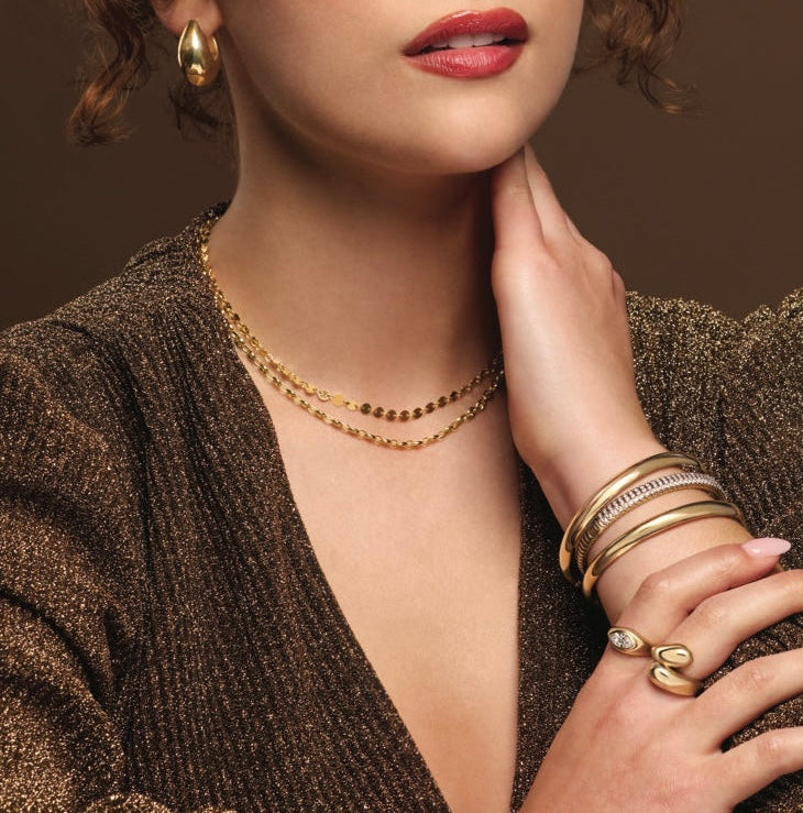 model wearing layered disc chain necklace