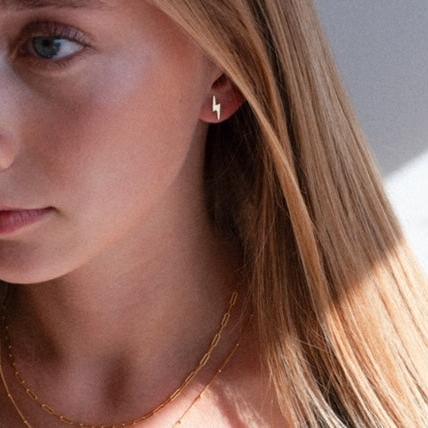gold filled lighting bolt studs on model