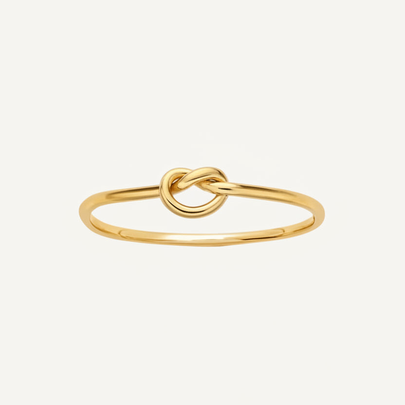 Gold knot ring on a white background
