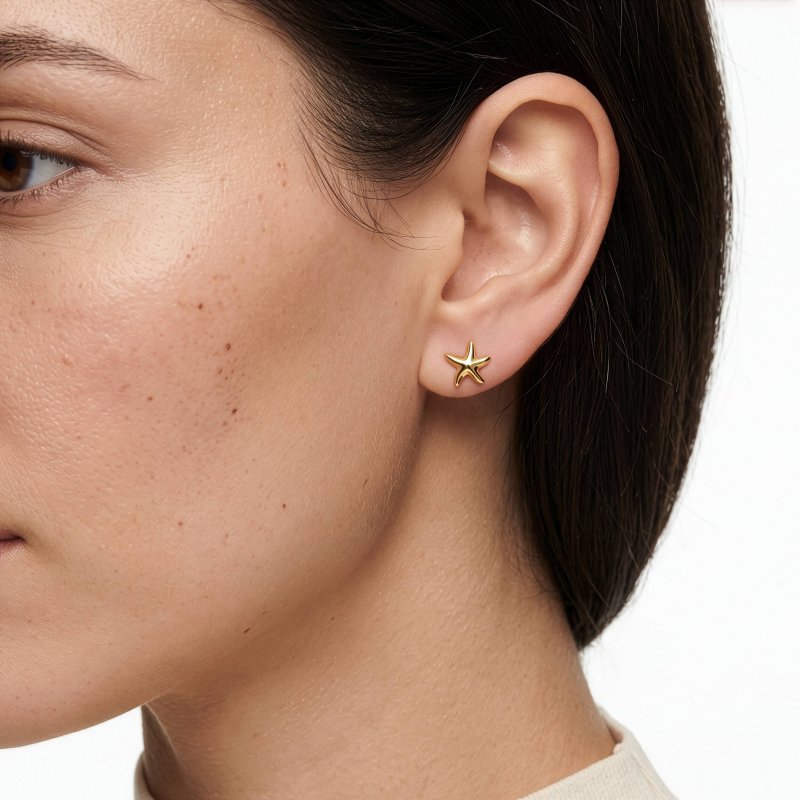 model wearing gold starfish studs