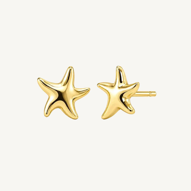 gold starfish studs on white background
