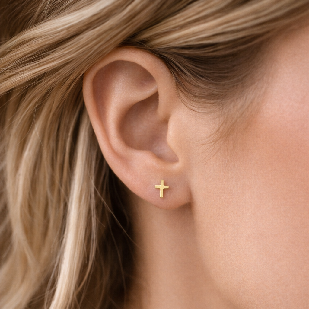 model wearing petite gold cross studs