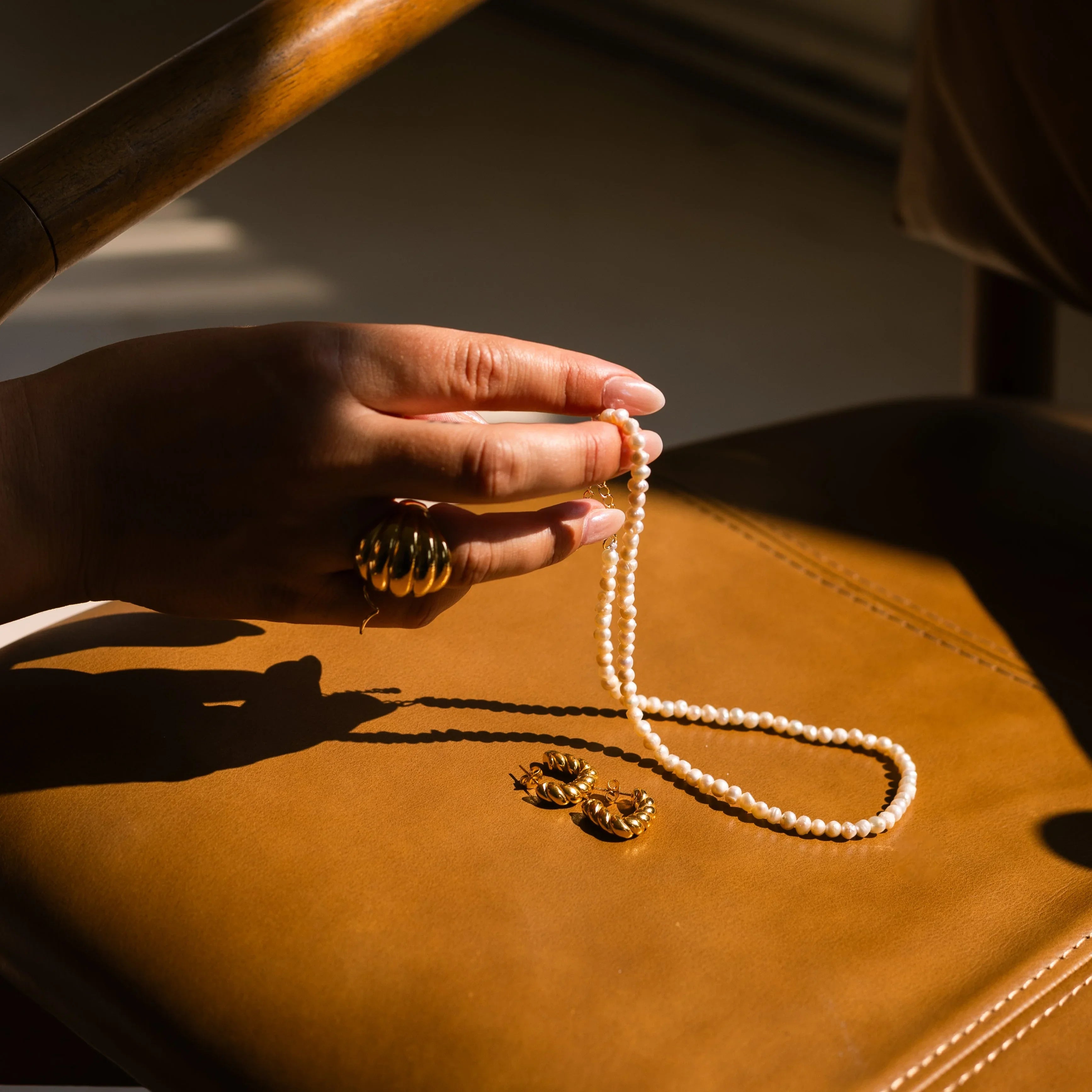 pearl necklace with gold plated statement earrings and ring
