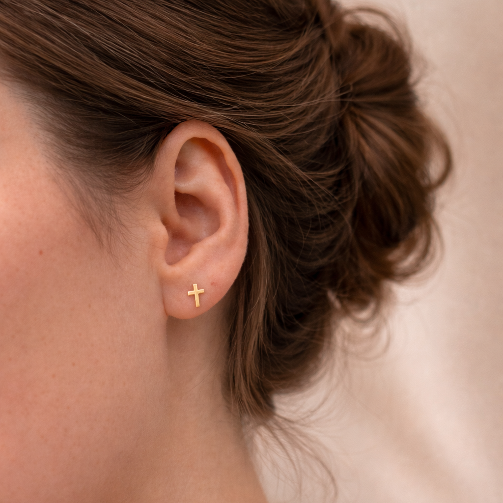 model wearing mini gold-filled cross studs