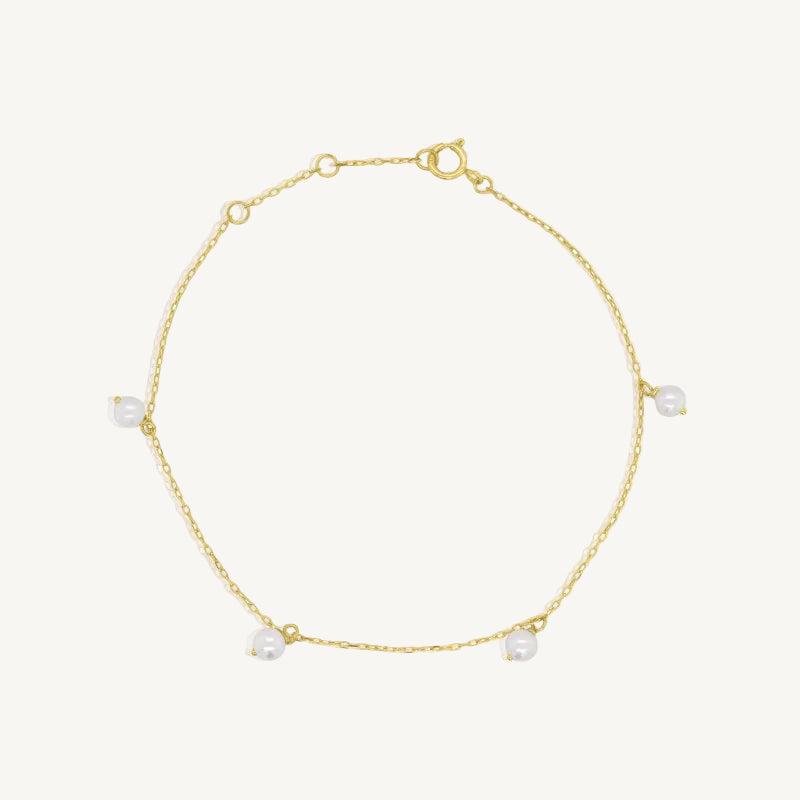 Gold bracelet with pearls on a white background