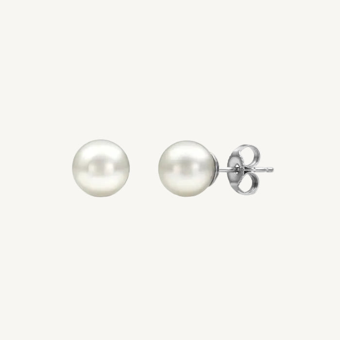 Pair of pearl stud earrings on a white background