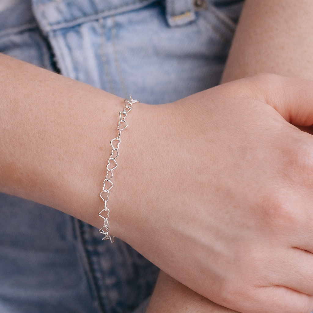 sterling silver heart chain bracelet on wrist 
