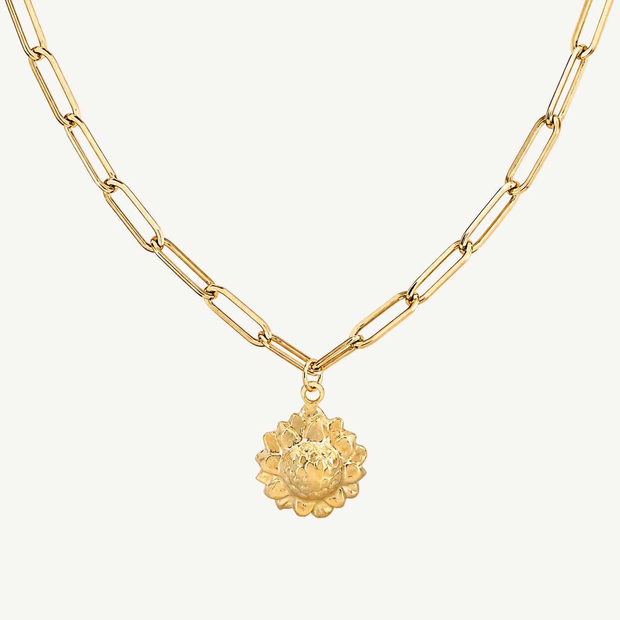 Gold necklace with a floral pendant on a white background
